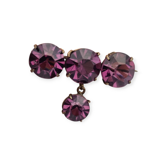 Antique brass brooch with faceted purple rhinestone pendant, circa 1930