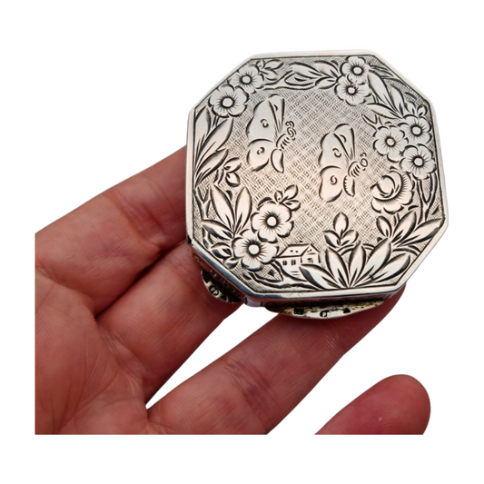 Antique octagonal powder compact in 800 silver engraved with butterflies and flowers, circa 1950