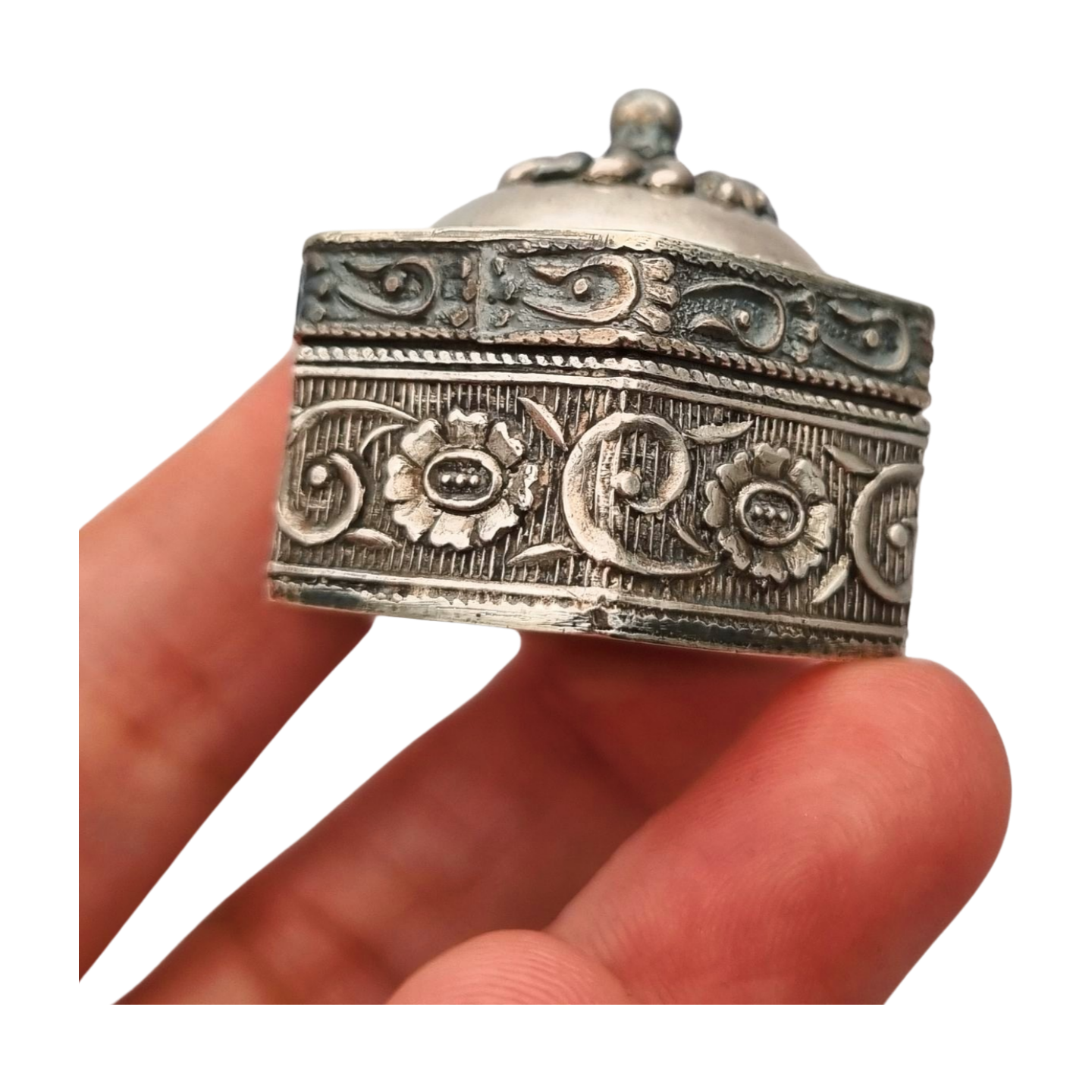 Hexagonal oriental ethnic silver box with floral relief and domed lid, circa 1970