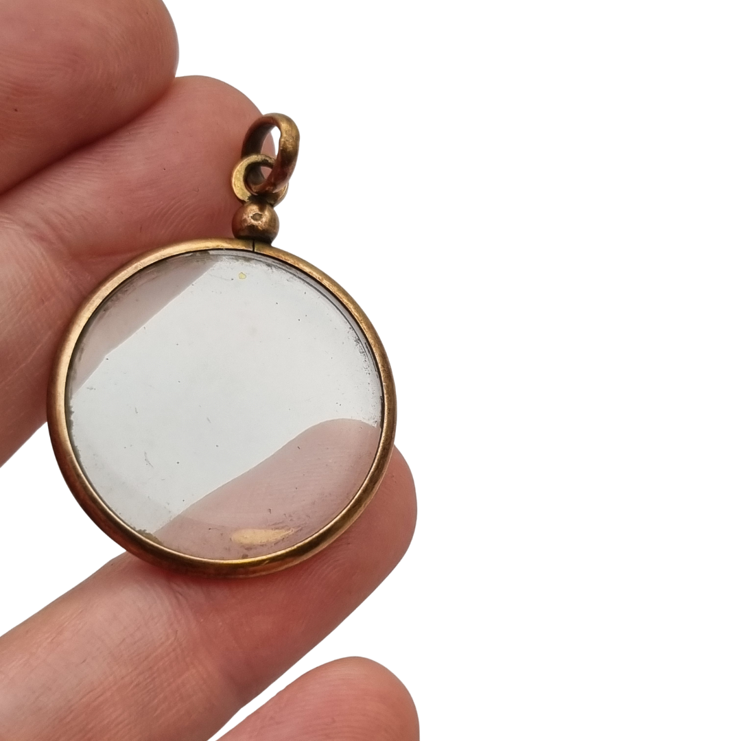 Circular gilded metal and glass locket, antique photo holder, c. 1900