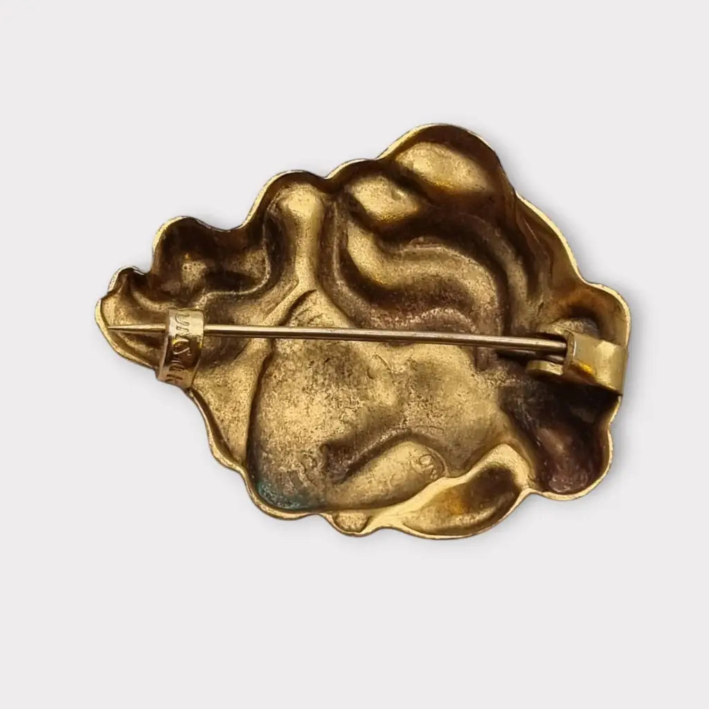 Broche de cabeza contemporáneo marca sunsilk en latón dorado. Bisutería