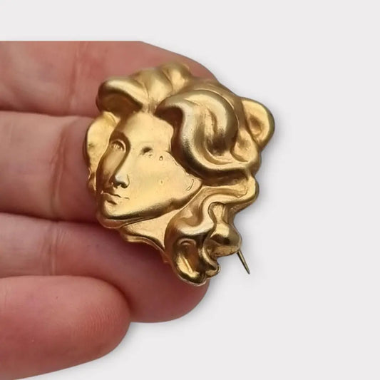 Broche de cabeza contemporáneo marca Sunsilk en latón dorado. Bisutería dorada.