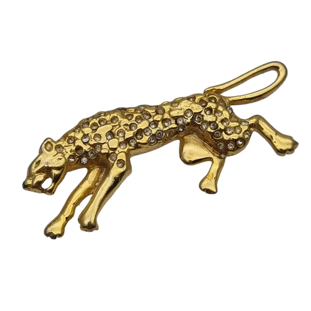 Broche de pantera dorado vintage con pedrería blanca.