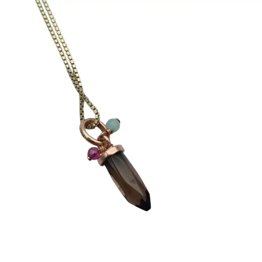 Colgante de cuarzo ahumado la marca tous en plata dorada con cadena.