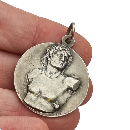 Vintage relic medal of Saint Sebastian from the Catacombs of Rome with early Christian symbols, Italy, ca. 1950–1960