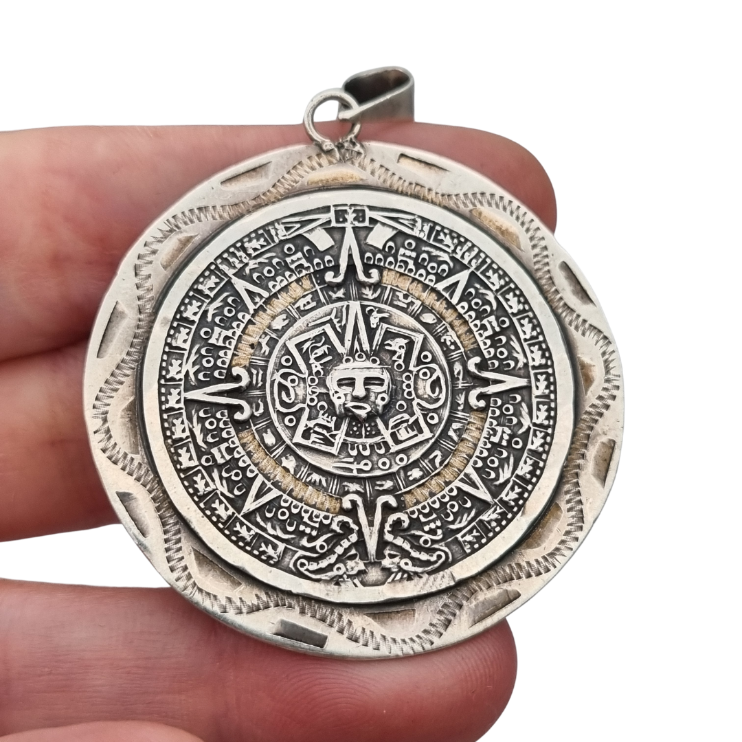 Reversible .925 sterling silver Aztec calendar and mask pendant, Mexico, 1960s-70s