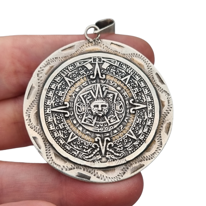 Reversible .925 sterling silver Aztec calendar and mask pendant, Mexico, 1960s-70s