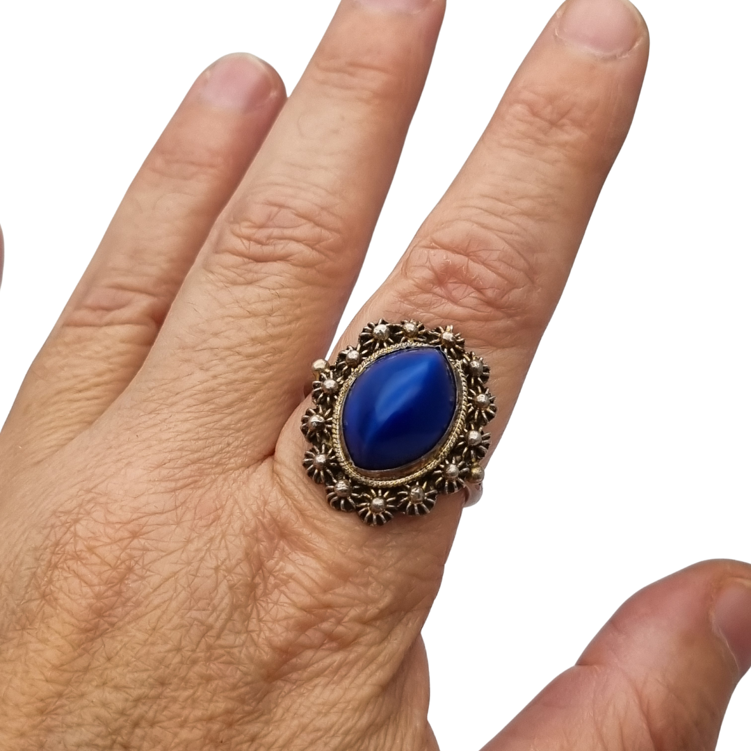 Mid-Century silver ring with blue cabochon and highly ornate floral frame, 1960