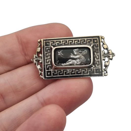 Antique rectangular metal and black enamel brooch with a classical scene, late 19th century
