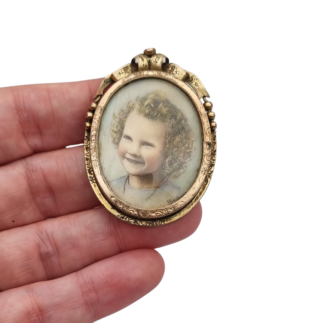 Belle Époque gilded metal locket brooch with Louis XV style miniature child portrait, circa 1890-1910