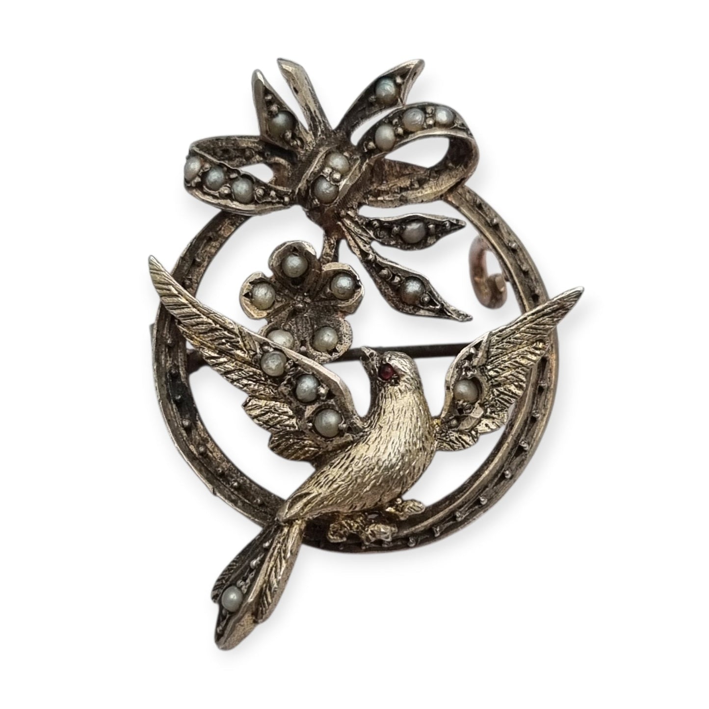 Broche eduardiano en plata con pájaro lazo perlas y rubí circa 1910