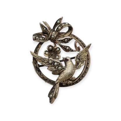 Broche eduardiano en plata con pájaro lazo perlas y rubí circa 1910