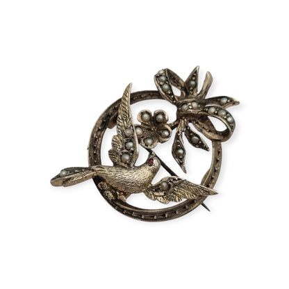 Broche eduardiano en plata con pájaro lazo perlas y rubí circa 1910