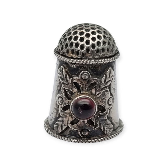 Antique silver thimble decorated with a red cabochon, circa 1960