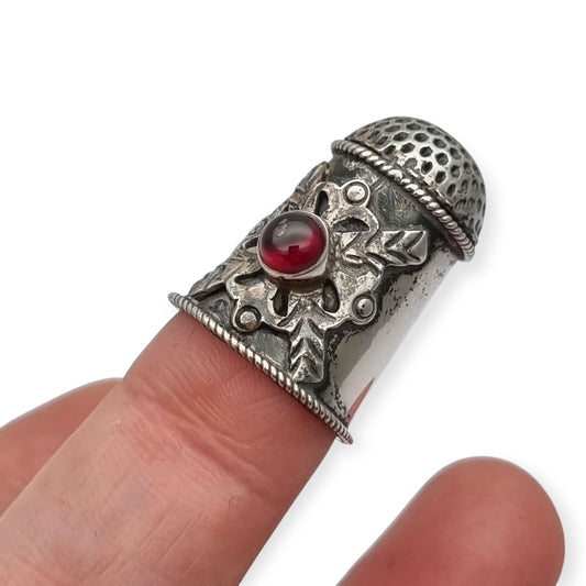 Antique silver thimble decorated with a red cabochon, circa 1960