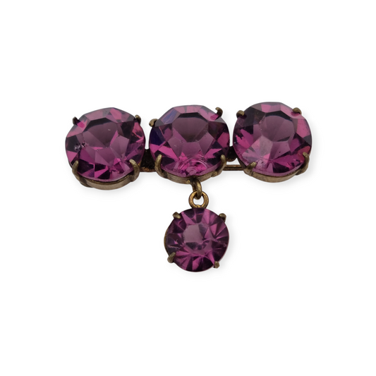 Antique brass brooch with faceted purple rhinestone pendant, circa 1930