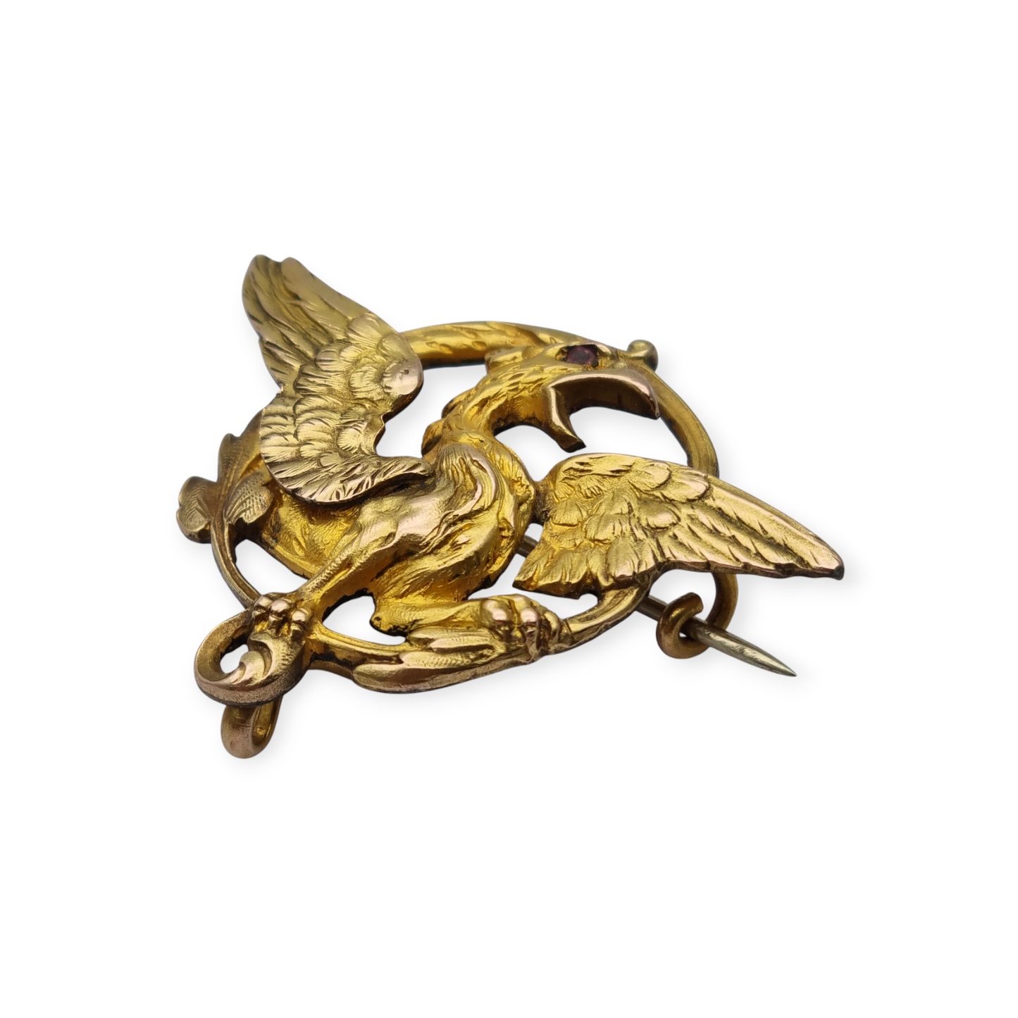 Broche Art Nouveau de grifo ORIA en oro laminado y ojo de rubí, circa 1910