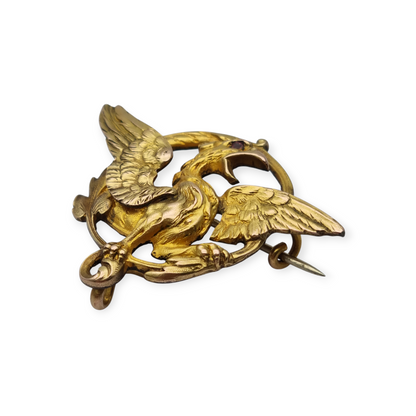 Broche Art Nouveau de grifo ORIA en oro laminado y ojo de rubí, circa 1910