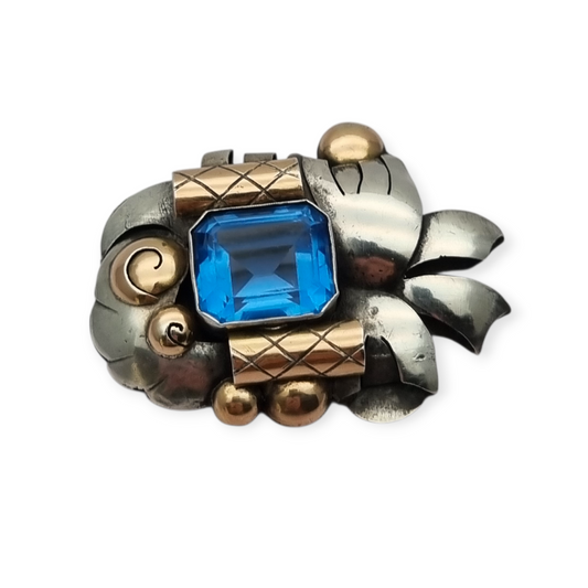 Art Deco Catalan brooch in silver with gold accents and simulated aquamarine, circa 1930-1940