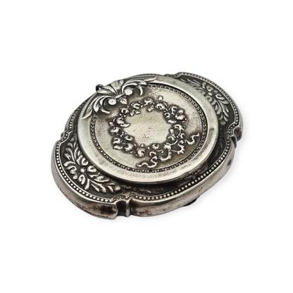 Antique Art Nouveau silver chatelaine powder compact with interior mirror, floral design, circa 1920.