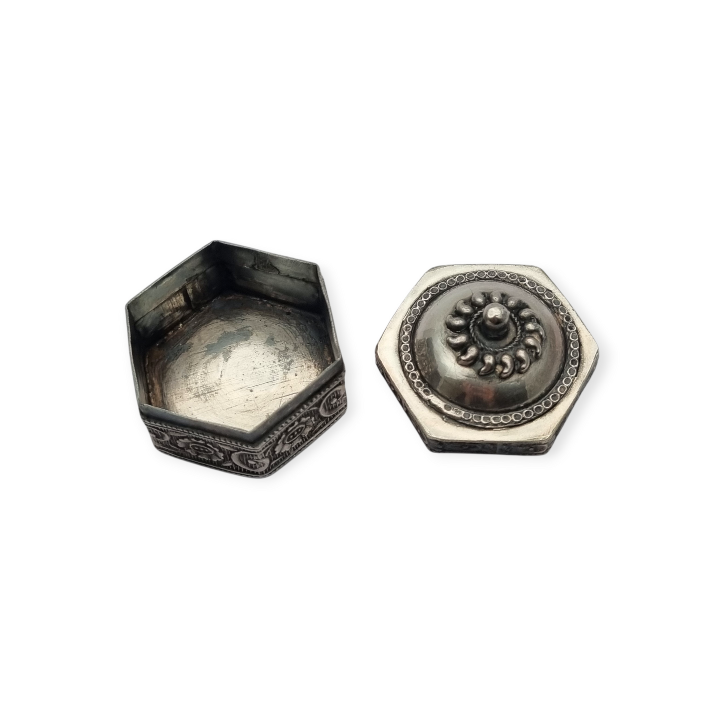 Hexagonal oriental ethnic silver box with floral relief and domed lid, circa 1970