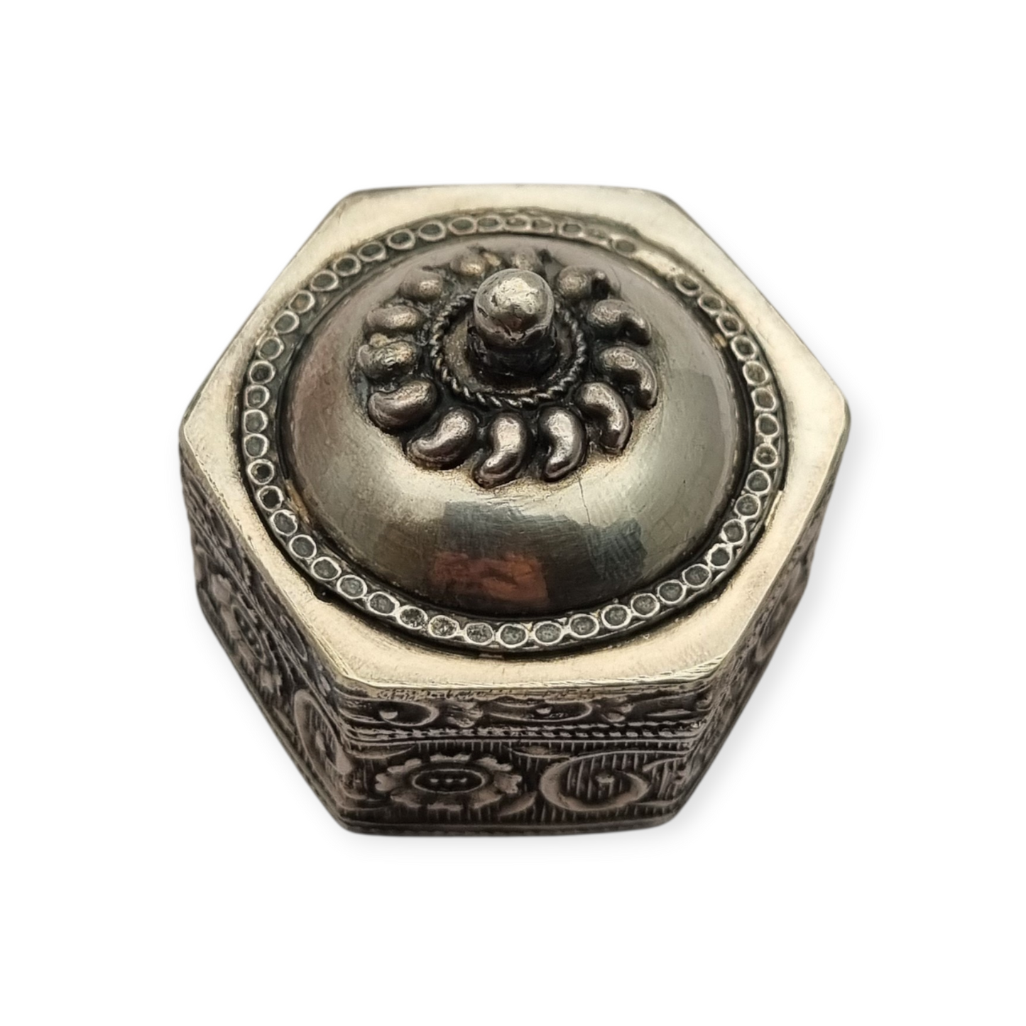 Hexagonal oriental ethnic silver box with floral relief and domed lid, circa 1970