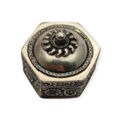 Hexagonal oriental ethnic silver box with floral relief and domed lid, circa 1970
