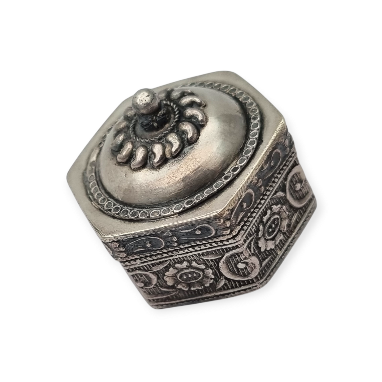 Hexagonal oriental ethnic silver box with floral relief and domed lid, circa 1970