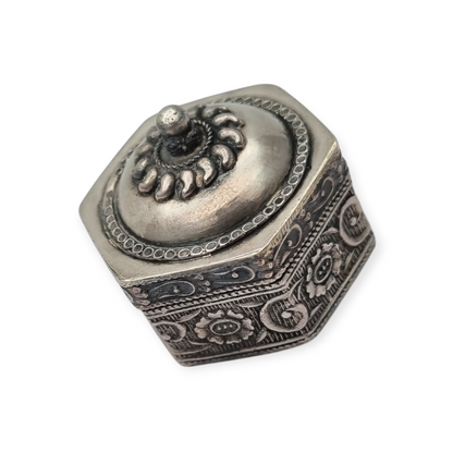 Hexagonal oriental ethnic silver box with floral relief and domed lid, circa 1970