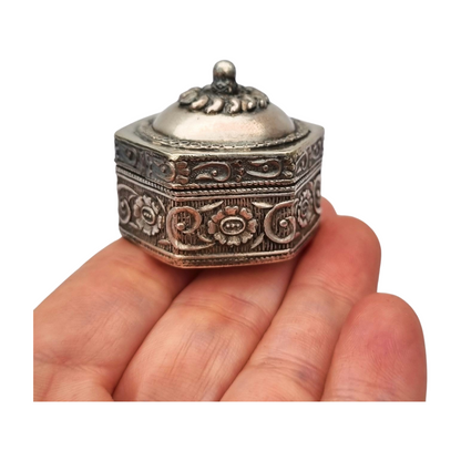 Hexagonal oriental ethnic silver box with floral relief and domed lid, circa 1970