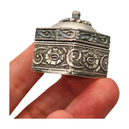 Hexagonal oriental ethnic silver box with floral relief and domed lid, circa 1970