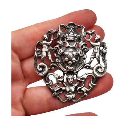 Neo-Renaissance silver brooch, heraldic shield with cherubs Italy 20th century