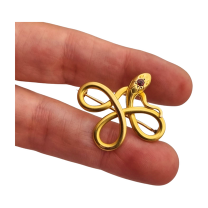 French FIX brooch with intertwined snake, rolled gold and red stone circa 1910
