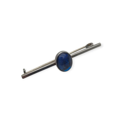 Broche antiguo de plata con cabujón azul ovalado, diseño minimalista siglo XX
