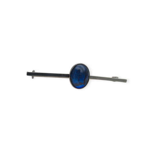 Broche antiguo de plata con cabujón azul ovalado, diseño minimalista siglo XX