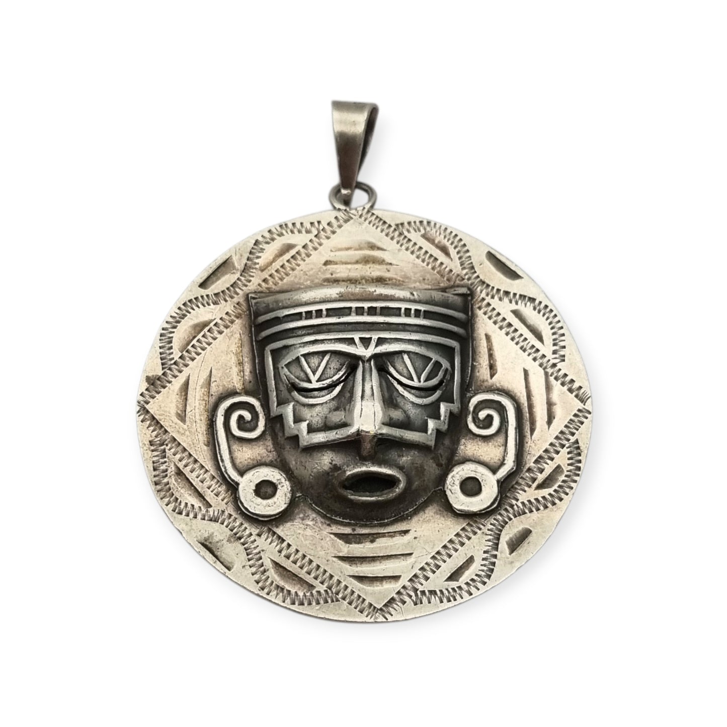 Reversible .925 sterling silver Aztec calendar and mask pendant, Mexico, 1960s-70s