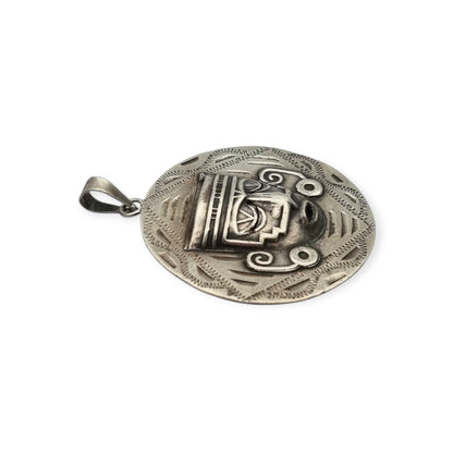 Reversible .925 sterling silver Aztec calendar and mask pendant, Mexico, 1960s-70s