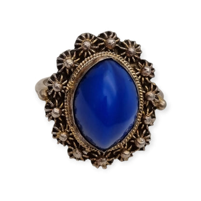 Mid-Century silver ring with blue cabochon and highly ornate floral frame, 1960