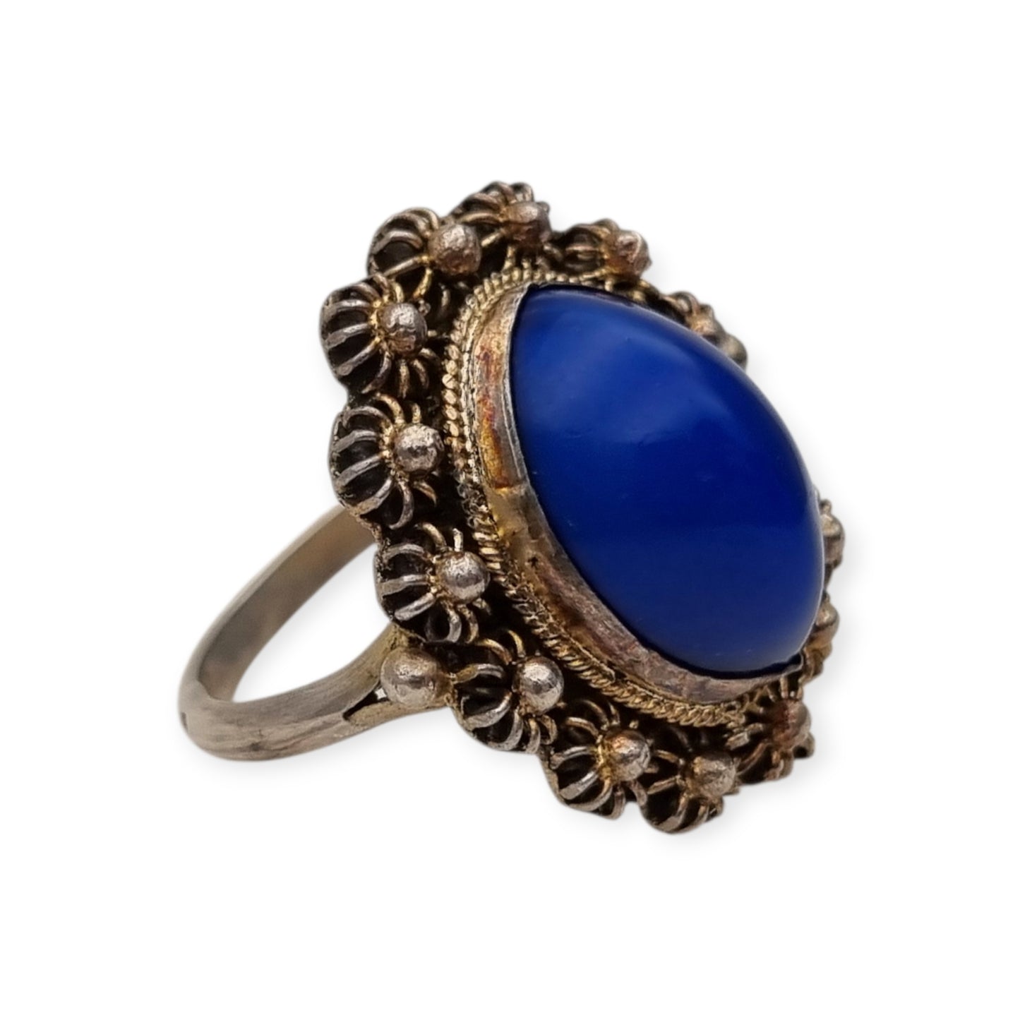 Mid-Century silver ring with blue cabochon and highly ornate floral frame, 1960
