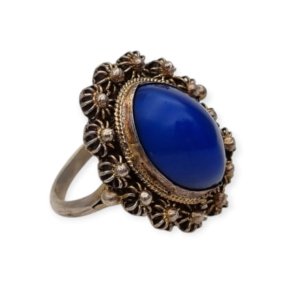 Mid-Century silver ring with blue cabochon and highly ornate floral frame, 1960