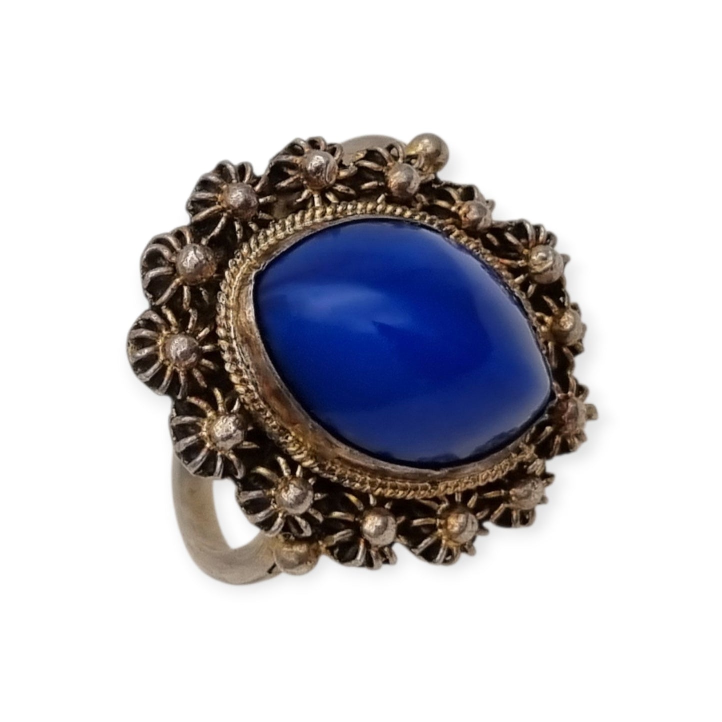 Mid-Century silver ring with blue cabochon and highly ornate floral frame, 1960