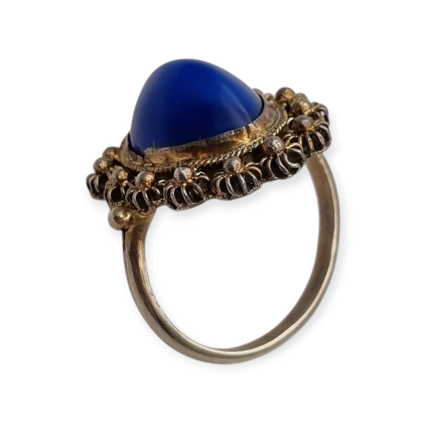 Mid-Century silver ring with blue cabochon and highly ornate floral frame, 1960