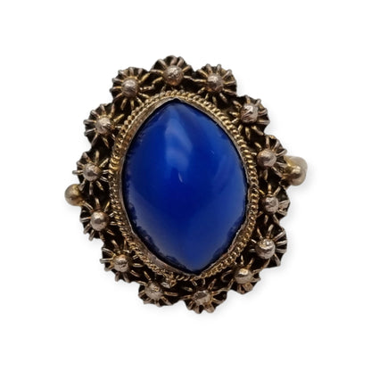 Mid-Century silver ring with blue cabochon and highly ornate floral frame, 1960