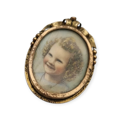 Belle Époque gilded metal locket brooch with Louis XV style miniature child portrait, circa 1890-1910