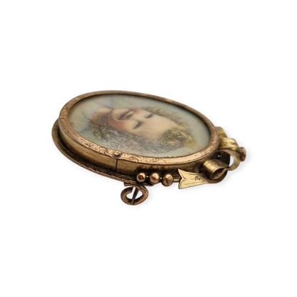 Belle Époque gilded metal locket brooch with Louis XV style miniature child portrait, circa 1890-1910