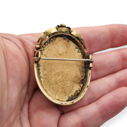 Belle Époque gilded metal locket brooch with Louis XV style miniature child portrait, circa 1890-1910