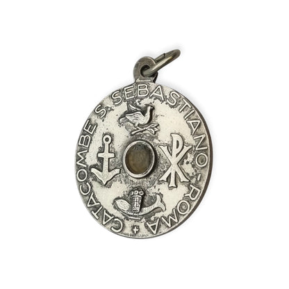 Vintage relic medal of Saint Sebastian from the Catacombs of Rome with early Christian symbols, Italy, ca. 1950–1960