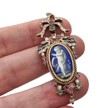 Antique winged cherub pendant in Gilt Silver with Enamel, Pearls, and Gems, ca. 18 70–1890