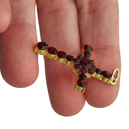 Vintage cross with garnet rhinestones and gold-tone metal religious style circa 1950