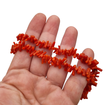 Boho necklace of natural red coral with irregular branches and metal clasp, circa 1970-80